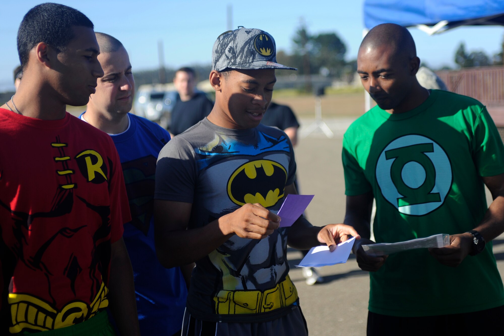 VANDENBERG AIR FORCE BASE, Calif. -- Airmen from the 381st Training Support Squadron get their first clue for Vandenberg's Run to Survive Safety Competition at the parade grounds here Tuesday, May 22, 2012. The competition had the participants run around to multiple locations on base testing their safety skills and knowledge. (U.S. Air Force photo/Staff Sgt. Andrew Satran)  
