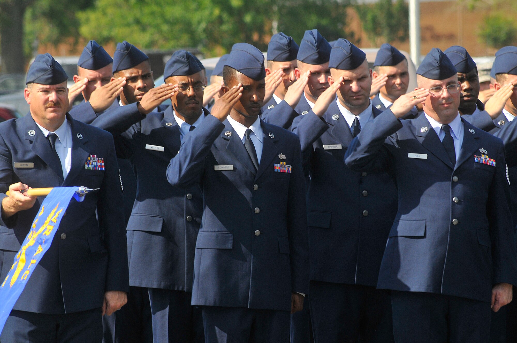 Warner Robins ALC Airmen salute during the lowering of the flag in a Memorial Day Retreat Ceremony Wed. The retreat included representatives of every organization on base. (U. S. Air Force photo by Sue Sapp)
