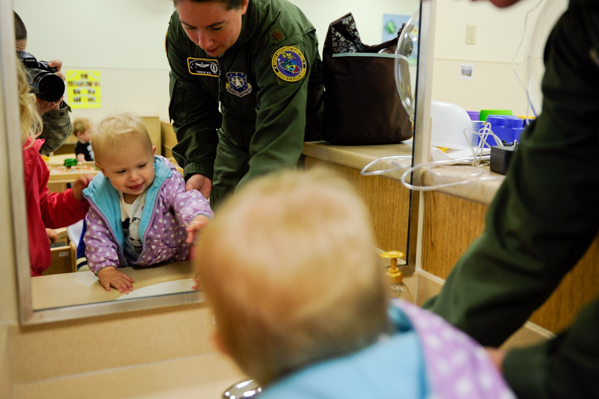 VANDENBERG AIR FORCE BASE, Calif. --  Maj. Jennifer Korby, the 614th Air Operations Center director of staff, washes her daughter Lexie's hands before leaving her at the new Child Development Center here Wednesday, May 23, 2012. The new CDC opened for business Monday and has the capacity to provide care for 172 children. (U.S. Air Force photo/Staff Sgt. Levi Riendeau)