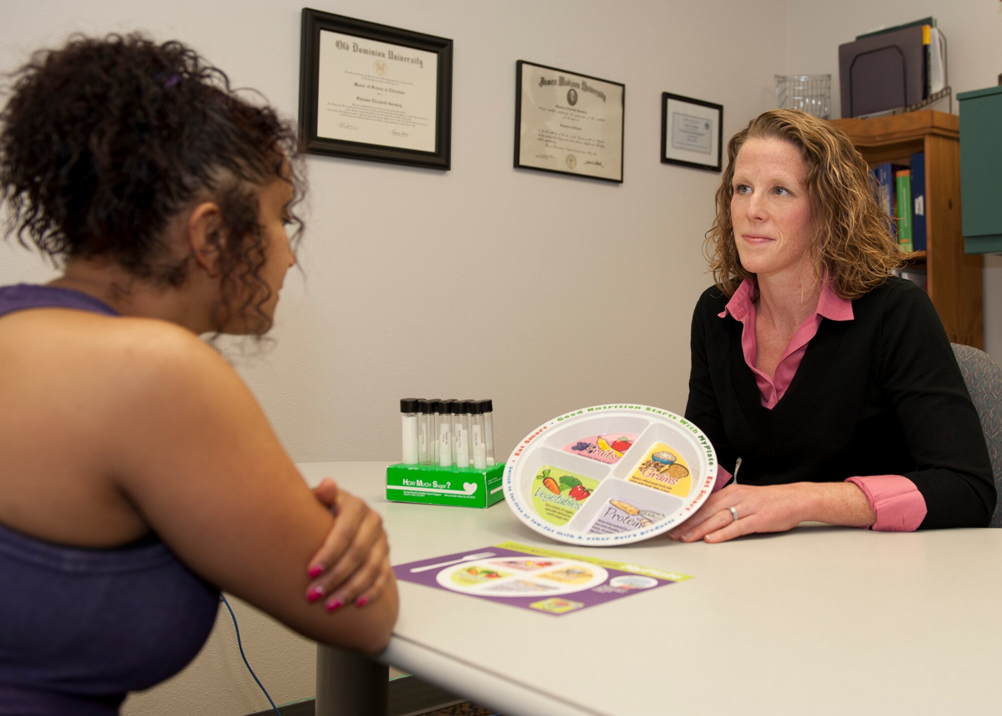 HOLLOMAN AIR FORCE BASE, N.M. -- Shannan Bergtholdt, the Health Promotion Program Manager at the Health and Wellness Center, helps a client Jan. 25. Bergtholdt uses a portion plate to educate the client on a proper diet. Consuming a diet comprised of primarily fruits, vegetables, whole grains, lean meats and low-fat dairy while limiting added sugars and fats is also a great way of keeping healthy and managing weight. (U.S. Air Force photo by Airman 1st Class Michael Shoemaker/Released)

 
