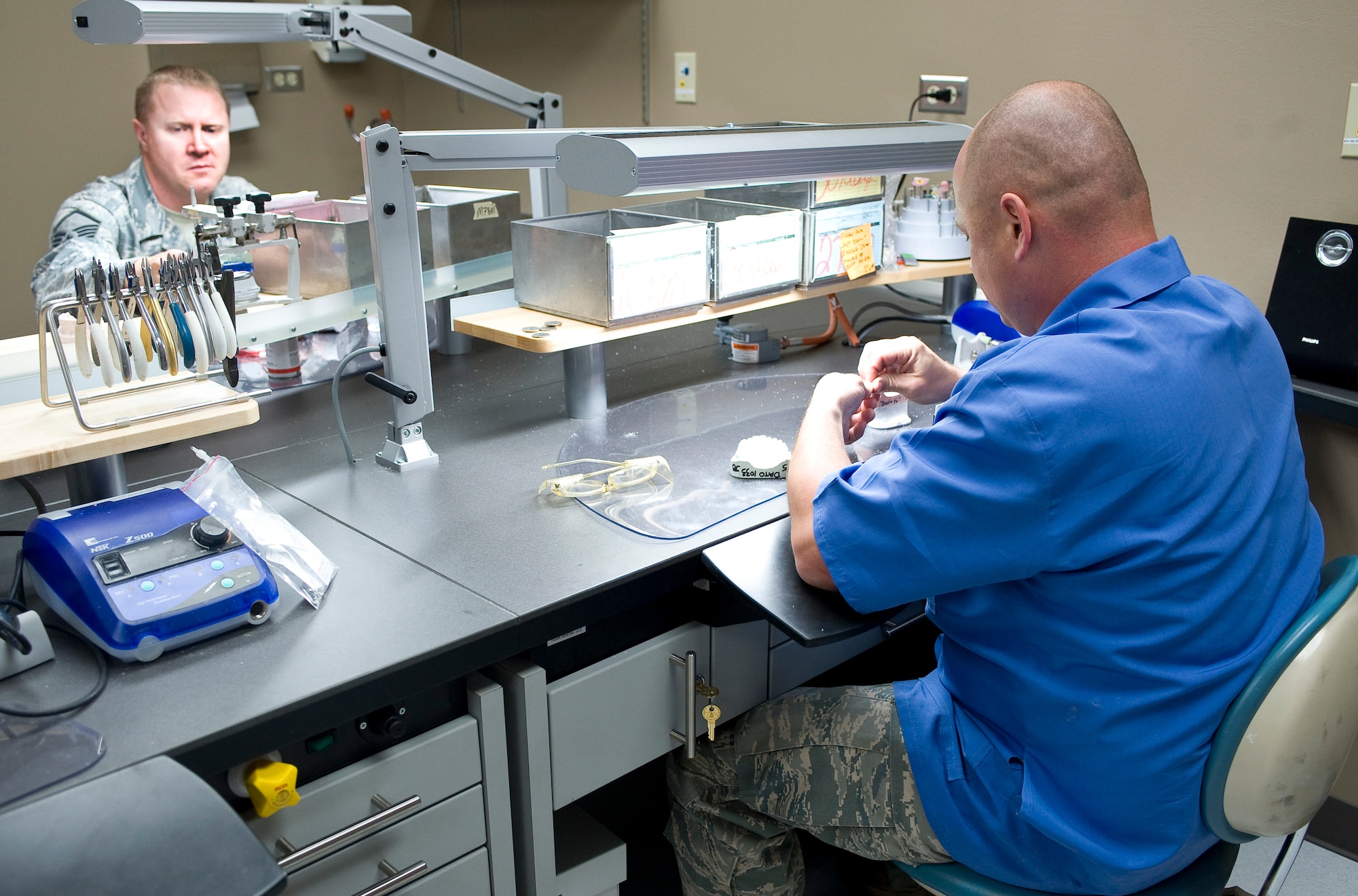 Master Sgt. Denny Shaffer, 2nd Dental Squadron laboratory flight chief, and Tech. Sgt. William Fitzpatrick, 2 DS laboratory technician, shape molds of wax teeth in the new dental lab on Barksdale Air Force Base, La., May 22. The new facility has eight fully-equipped workstations and two adjacent rooms for additional jobs that require specialized equipment. (U.S. Air Force photo/Staff Sgt. Chad Warren)(RELEASED)