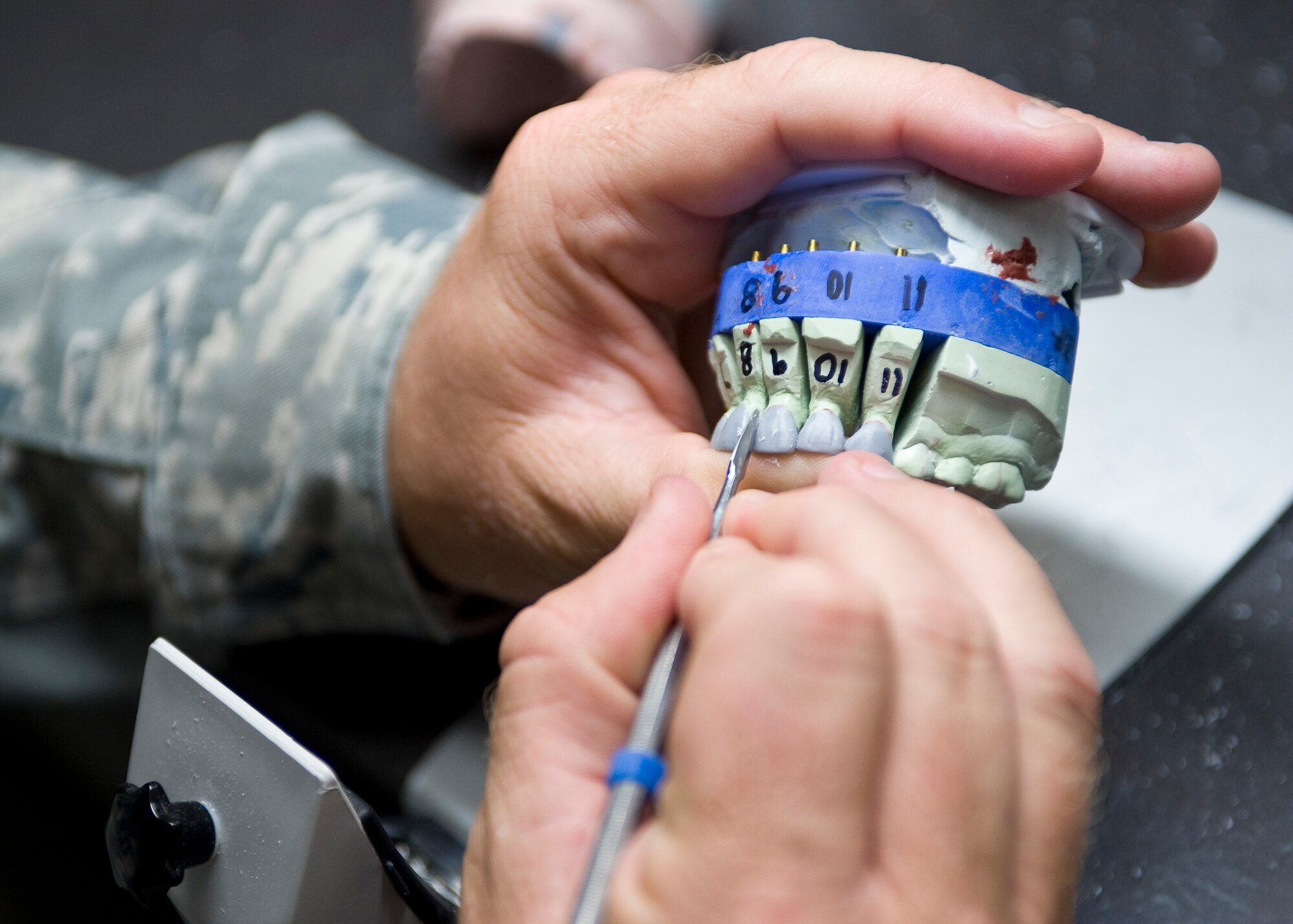 Master Sgt. Denny Shaffer, 2nd Dental Squadron laboratory flight chief, shapes molds of wax teeth in the new dental lab on Barksdale Air Force Base, La., May 22. When finished, these wax molds will be used to create artificial porcelain teeth for a patient. (U.S. Air Force photo/Staff Sgt. Chad Warren)(RELEASED)