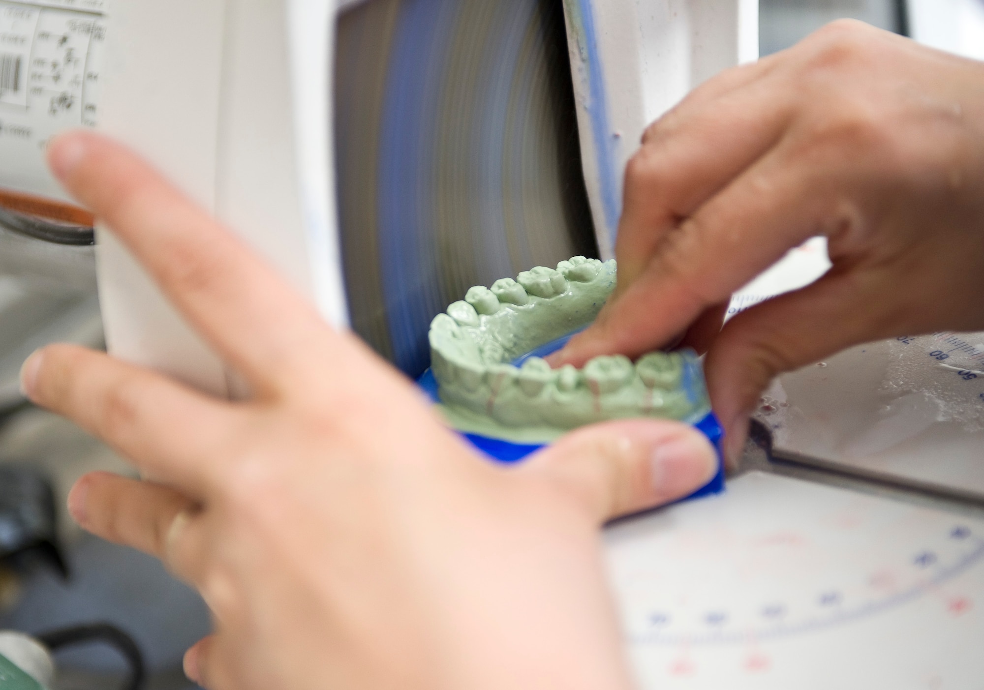 Senior Airman Heather Nowak, 2nd Dental Squadron laboratory technician, grinds a cast of a patient's teeth in the new dental lab on Barksdale Air Force Base, La., May 22. Grinding is one of the first steps when creating products such as crowns for patients. (U.S. Air Force photo/Staff Sgt. Chad Warren)(RELEASED)