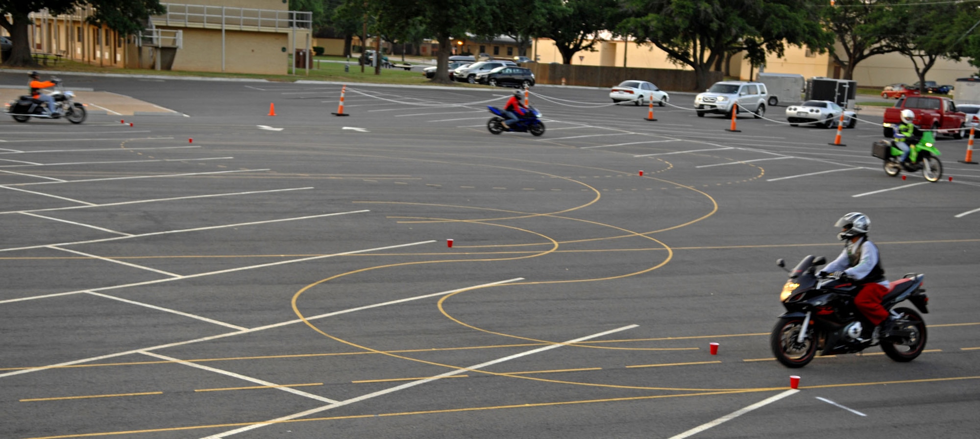 Motorcyclists from Barksdale Air Force Base, La. practice gradual increasing radius curves at the motorcycle safety range here May 21. The range can be used by riders of different types of two-wheeled motorcycles including cruisers, dual-sport bikes and sport bikes. (U.S. Air Force photo/Staff Sgt. Jason McCasland)(RELEASED)