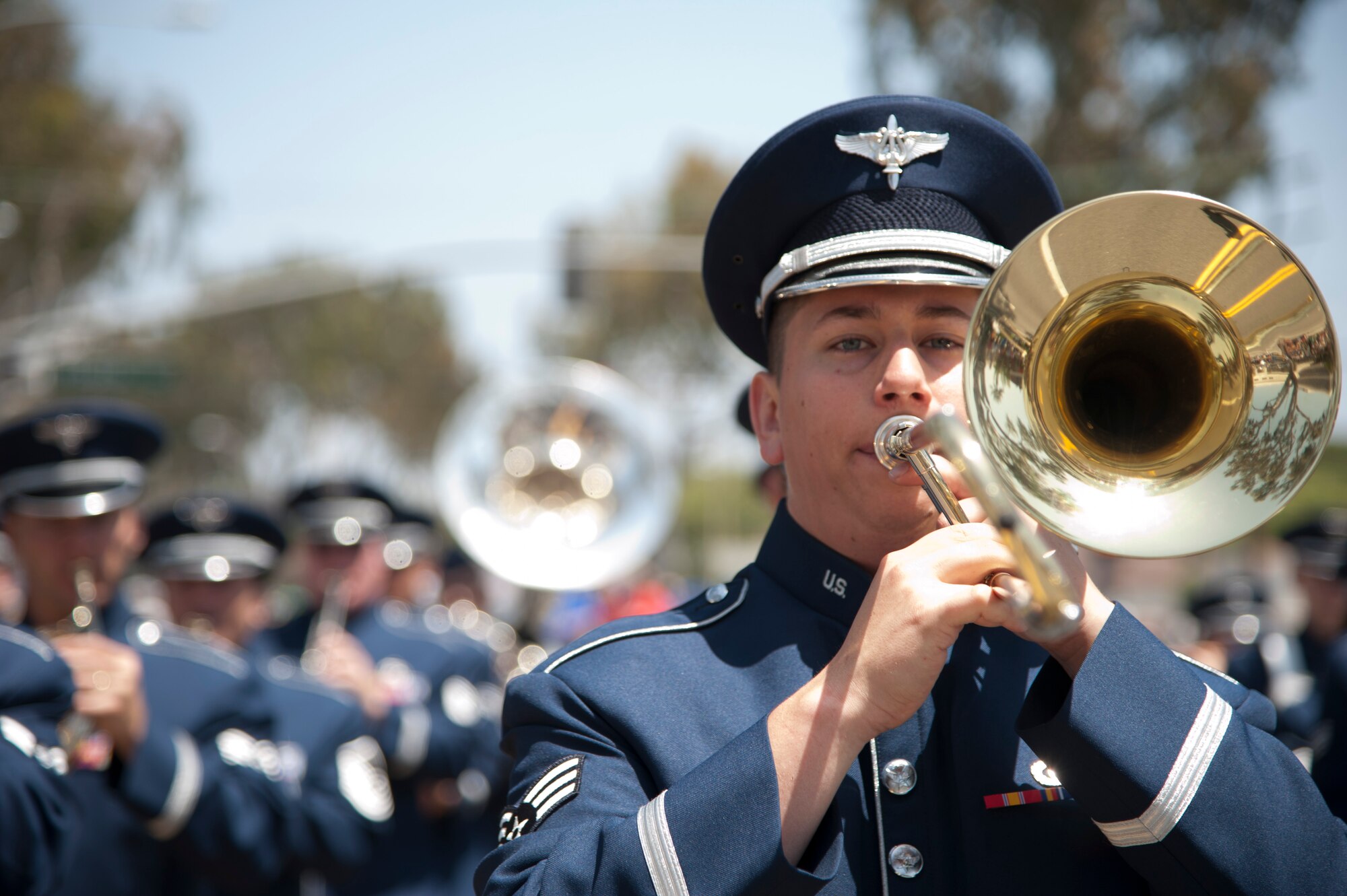 Senior Airman Ryan Terronez, USAF Band of the Golden West trombone player, marches with the band during the Armed Forces Day parade in Torrance, CA Saturday.