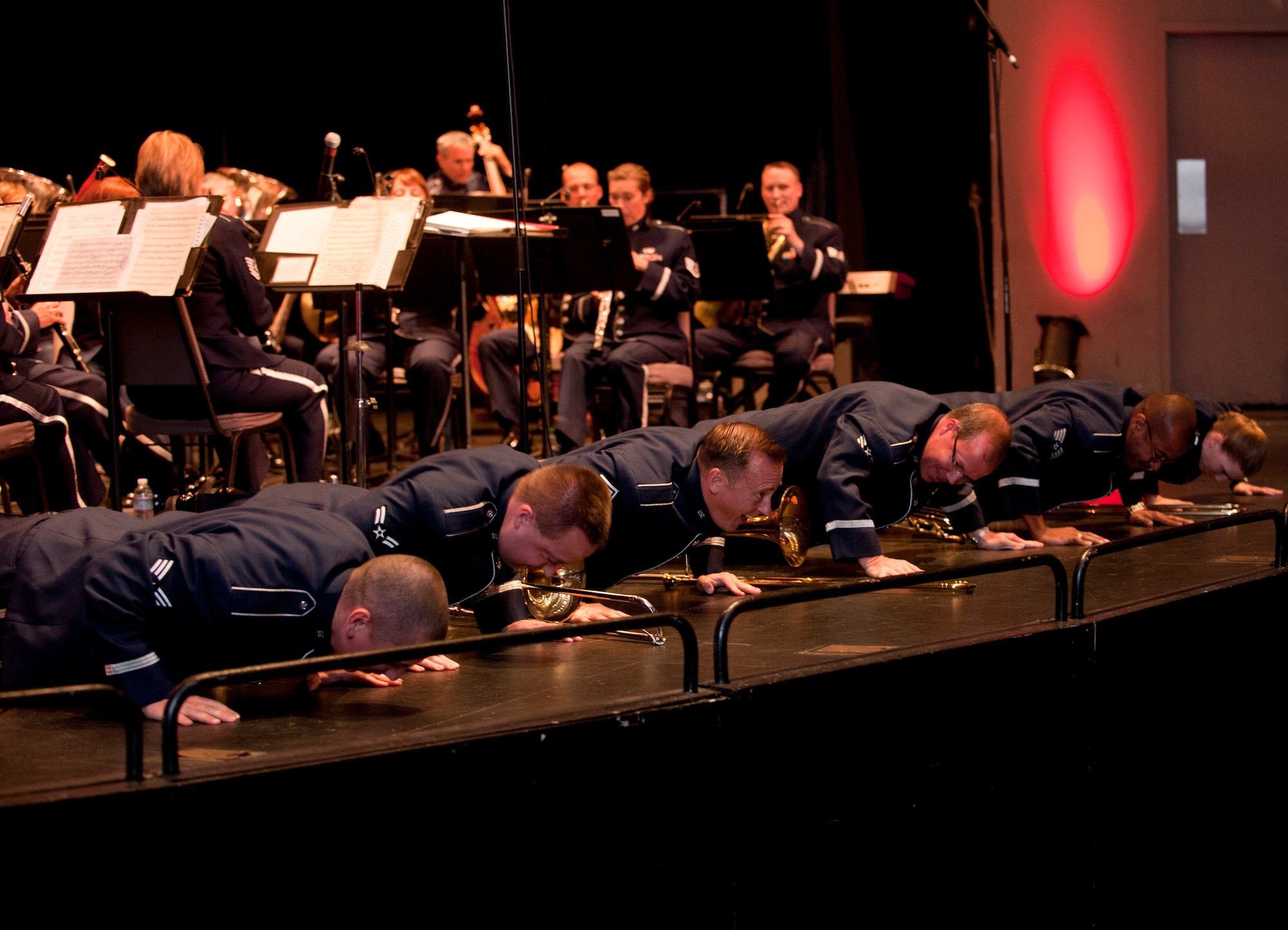 Members of the USAF Band of the Golden West tombone section get down to do some push-ups during their solo in the Armed Forces Day Concert in Torrance, CA May 18.