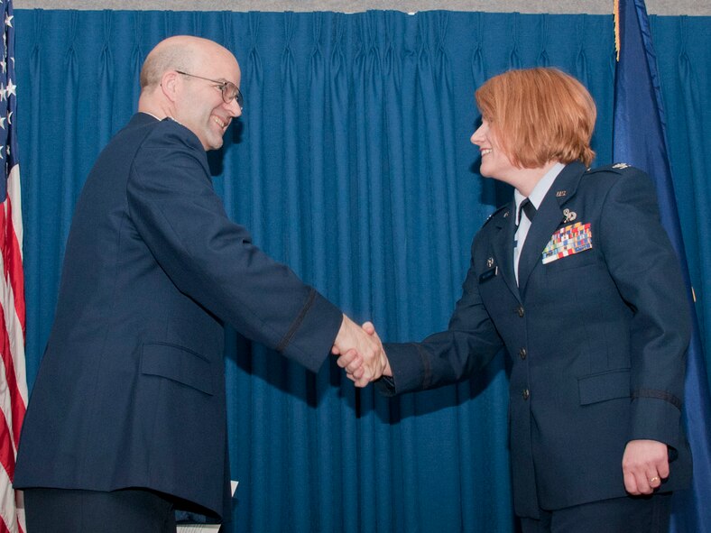 JOINT BASE ELMENDORF-RICHARDSON -- Lt. Col. Patty Wilbanks, commander of the 176 Mission Support Group, is promoted to colonel here May 20.  Col. Robert A. K. Doehl, vice commander of the 176 Wing congratulates her. National Guard photo by Staff Sgt. N. Alicia Goldberger.