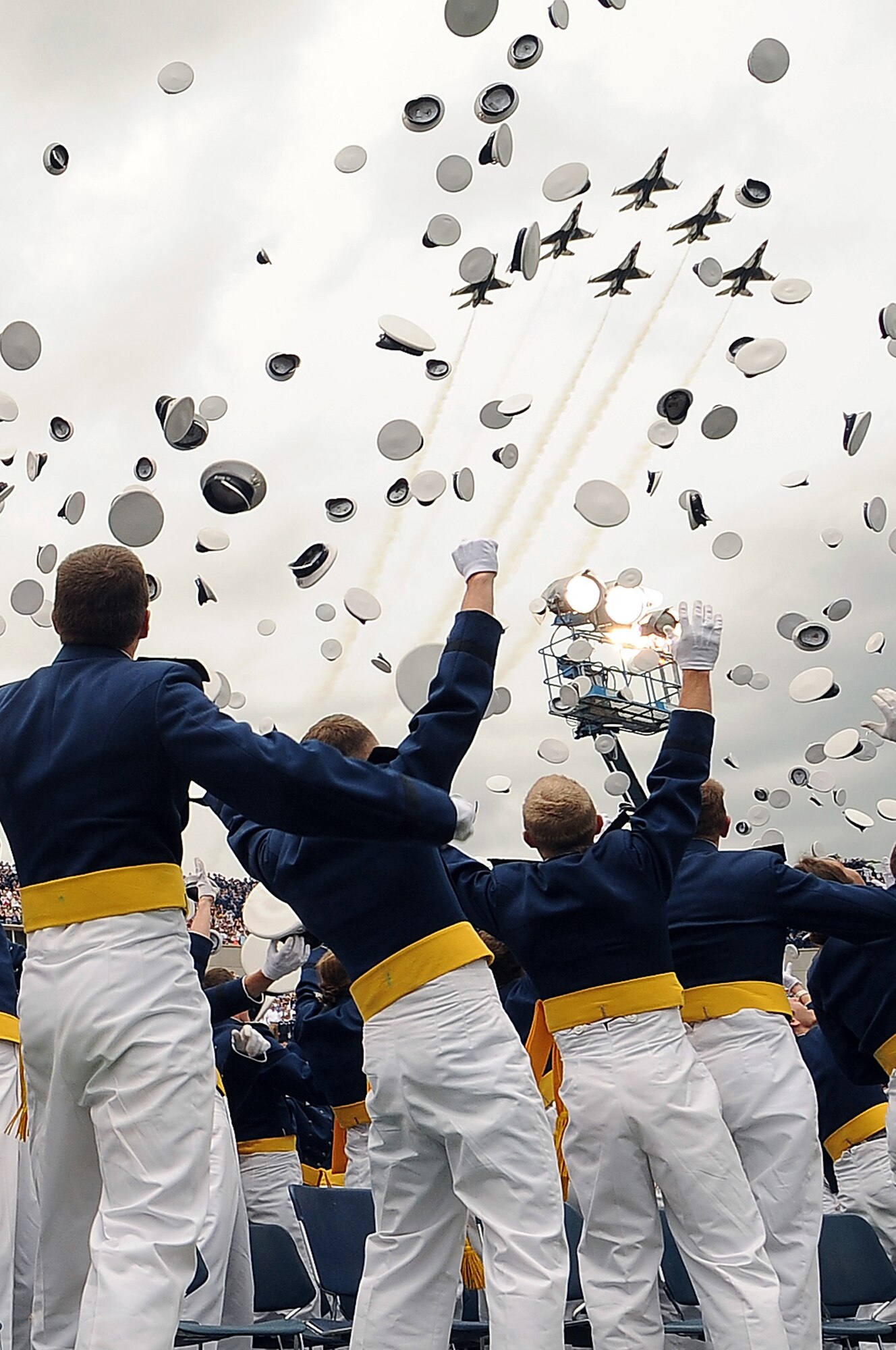 Newly minted second lieutenants toss their hats skyward as the U.S. Air Force Thunderbirds fly over Falcon Stadium during the Air Force Academy Class of 2012 graduation ceremony May 23, 2012 in Colorado Springs, Colo. A total of 1,073 graduates crossed the stage and received their diplomas from President Barack Obama. (U.S. Air Force photo/Elizabeth Andrews)