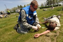 MINOT AIR FORCE BASE, N.D. -- Staff Sgt. James Strawn, 69th Bomb Squadron independent duty medical technician, identifies injuries on a simulated patient during a Major Accident Response Exercise here May 17. Upon identifying injuries of patient, Strawn determines medical action to take—whether immediate or delayed support, depending on severity of wounds. (U.S. Air Force photo/Senior Airman Jose L. Hernandez)