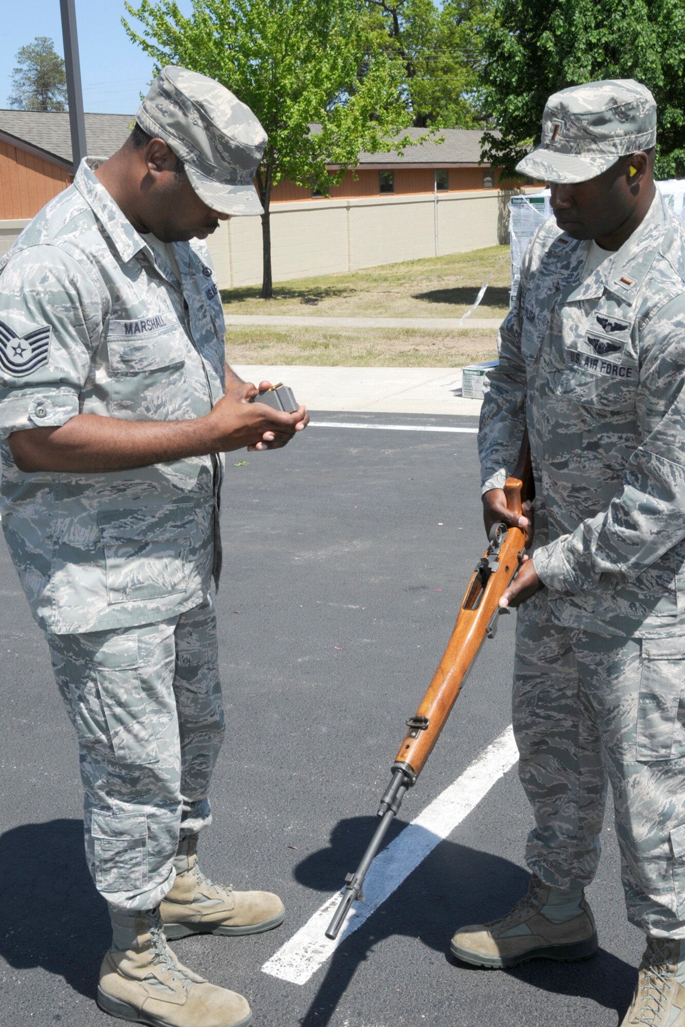 TSgt. Ronald Marhall, a member of the Wright Patterson Air Force Base Honor Guard, provides instruction in ceremonial rifle handling to 2nd Lt. Scott Wilson, a member of the 110th Airlift Wing, Michigan Air National Guard, during honor guard training at the Alpena Combat Readiness Training Center, Mich., May 23, 2012. Honor Guard Airmen say it is essential that honors are properly rendered to all fallen Airmen. (U.S. Air Force photo by TSgt. David Kujawa)