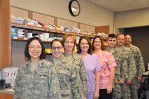 From left to right: Capt. Elaine Sit, Senior Airman Rachael Santiago, Master Sgt. Shelly Beckel, Tonya Nordstrom, Marisa Dolbeare, Staff Sgt. Christopher Harris, Maj. Scott Olech, and Chief Master Sgt. Kevin Jurgella.           

MINOT AIR FORCE BASE, N.D. -- The mission of the 5th Medical Group's pharmacy is to support and provide medications for the all active duty military members, their families, and all retirees in the area. They strive to provide the best possible customer service to allow a stress-free interaction in a quick and efficient manner.  Their goal is to care for everyone in such a way that the warfighter may focus on his or her mission and not worry about how they or their families are to receive their medications.  The Minot Air Force Base pharmacy carries out this mission by providing prompt, safe and reliable pharmaceutical care via the safest and latest pharmacy technology to a population of over 12,700 Airmen, retired military and families. Recently, the automated refill machine was relocated to ambulance services to provide 'round the clock availability. (Photo Submission/Staff Sgt. Carmen Washington)                        