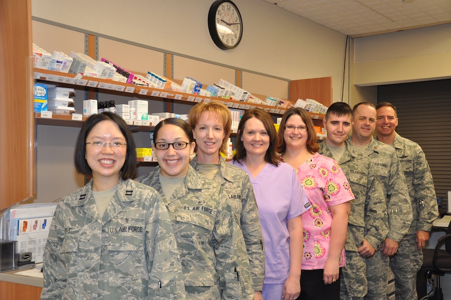From left to right: Capt. Elaine Sit, Senior Airman Rachael Santiago, Master Sgt. Shelly Beckel, Tonya Nordstrom, Marisa Dolbeare, Staff Sgt. Christopher Harris, Maj. Scott Olech, and Chief Master Sgt. Kevin Jurgella.           

MINOT AIR FORCE BASE, N.D. -- The mission of the 5th Medical Group's pharmacy is to support and provide medications for the all active duty military members, their families, and all retirees in the area. They strive to provide the best possible customer service to allow a stress-free interaction in a quick and efficient manner.  Their goal is to care for everyone in such a way that the warfighter may focus on his or her mission and not worry about how they or their families are to receive their medications.  The Minot Air Force Base pharmacy carries out this mission by providing prompt, safe and reliable pharmaceutical care via the safest and latest pharmacy technology to a population of over 12,700 Airmen, retired military and families. Recently, the automated refill machine was relocated to ambulance services to provide 'round the clock availability. (Photo Submission/Staff Sgt. Carmen Washington)                        