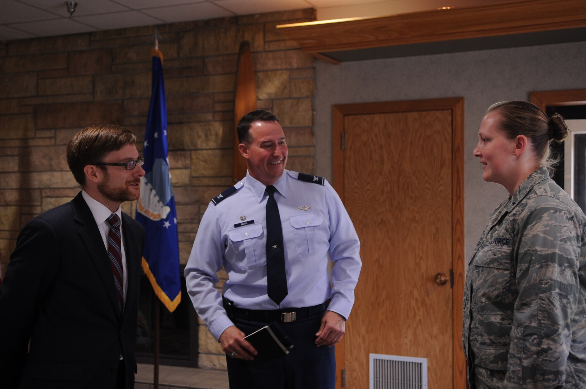 Dr. Jaime Morin, Assistant Secretary of Air Force Financial Management and Comptroller, and Col. Tim Bush, 319th Air Base Wing commander, speak with 1st Lt. Helen Barfield, 319th Comptroller Squadron, on Grand Forks Air Force Base, N.D., May 22, 2012. Morin toured the base after serving as the keynote speaker for the 2012 Unmanned Aircraft Systems Summit in Grand Forks city.