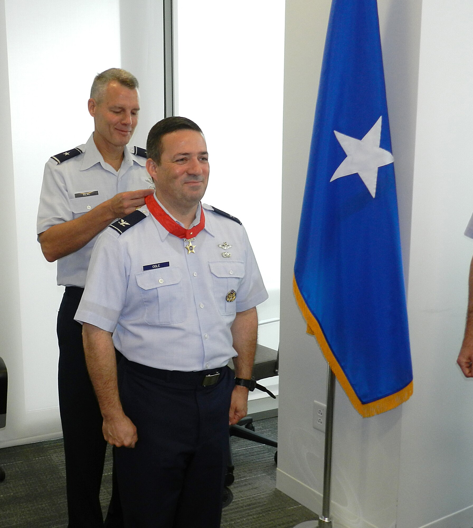 Brig. Gen. Brian Neal, the commander of the Air National Guard Readiness Center at Joint Base Andrews, Md., presents Col. Michael Ogle, the director of logistics for the ANG at the ANGRC, with the Lone Star Distinguished Service Medal from the state of Texas May 22, 2012 at the ANGRC for his exceptionally outstanding performance of duty while he was assigned to the 149th Fighter Wing, Lackland Air Force Base, Texas. The state of Texas awards the Lone Star Distinguished Service Medal to service members who while serving with the Texas military forces, distinguished themself by exceptionally outstanding achievement or service to the state in the performance of a duty of great responsibility and the Texas Adjutant General is the approving authority for this honor. (National Guard photo by Staff Sgt. Lorenzo Parnell/RELEASED)