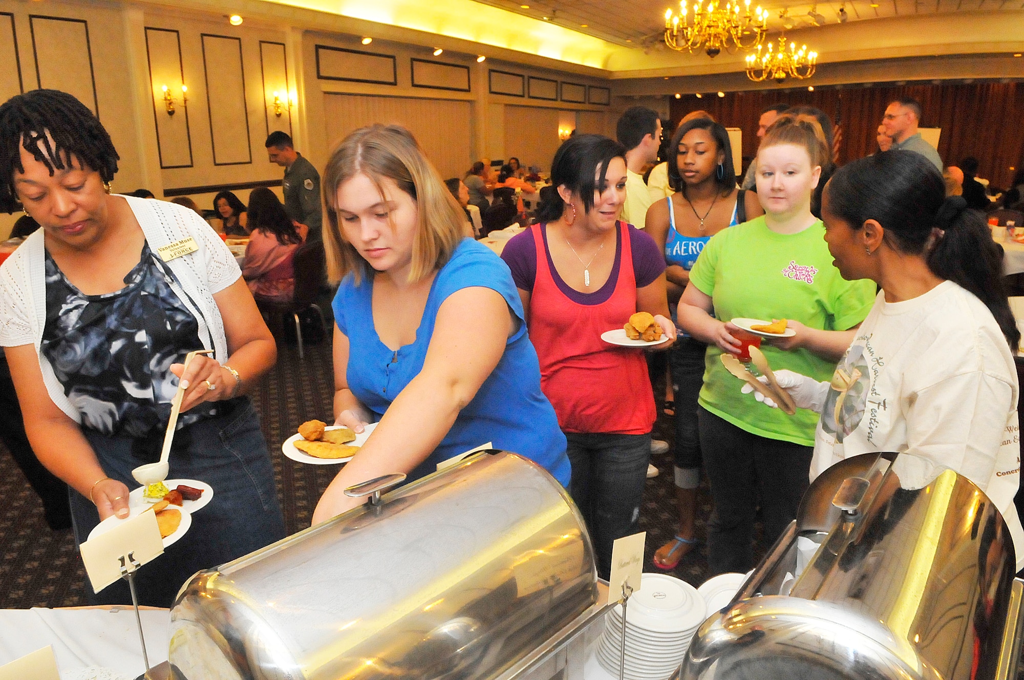 Spouses enjoy a buffet at the Military Spouse Appreciation reception at Horizons Tuesday. (U. S. Air Force photo by Sue Sapp)