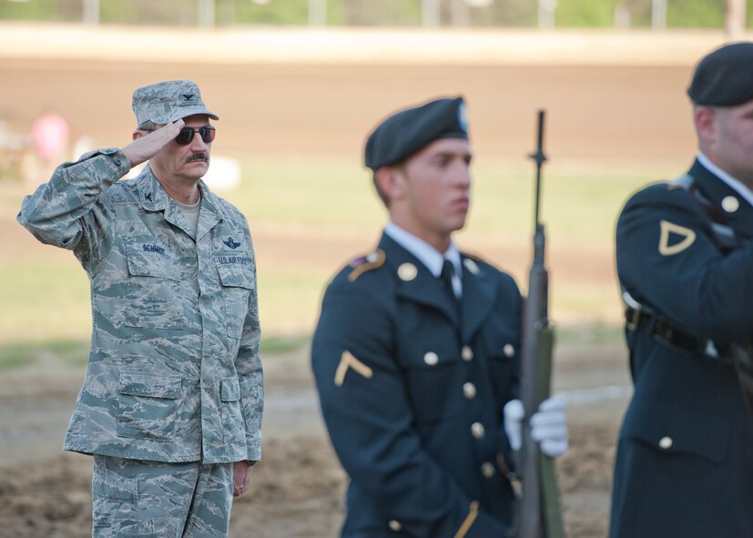 910th Airlift Wing Commander Colonel Reinhard Schmidt salutes during the singing of the National Anthem at the Sharon Speedway Saturday, May 19, 2012. Opening ceremony for the race were held in honor of Armed Forces Day. Service members from Youngstown Air Reserve Station participated in a Joint Service Color Guard to present the colors, and a 910th Airlift Wing C-130H Hercules aircraft performed a fly-over to conclude the ceremony.