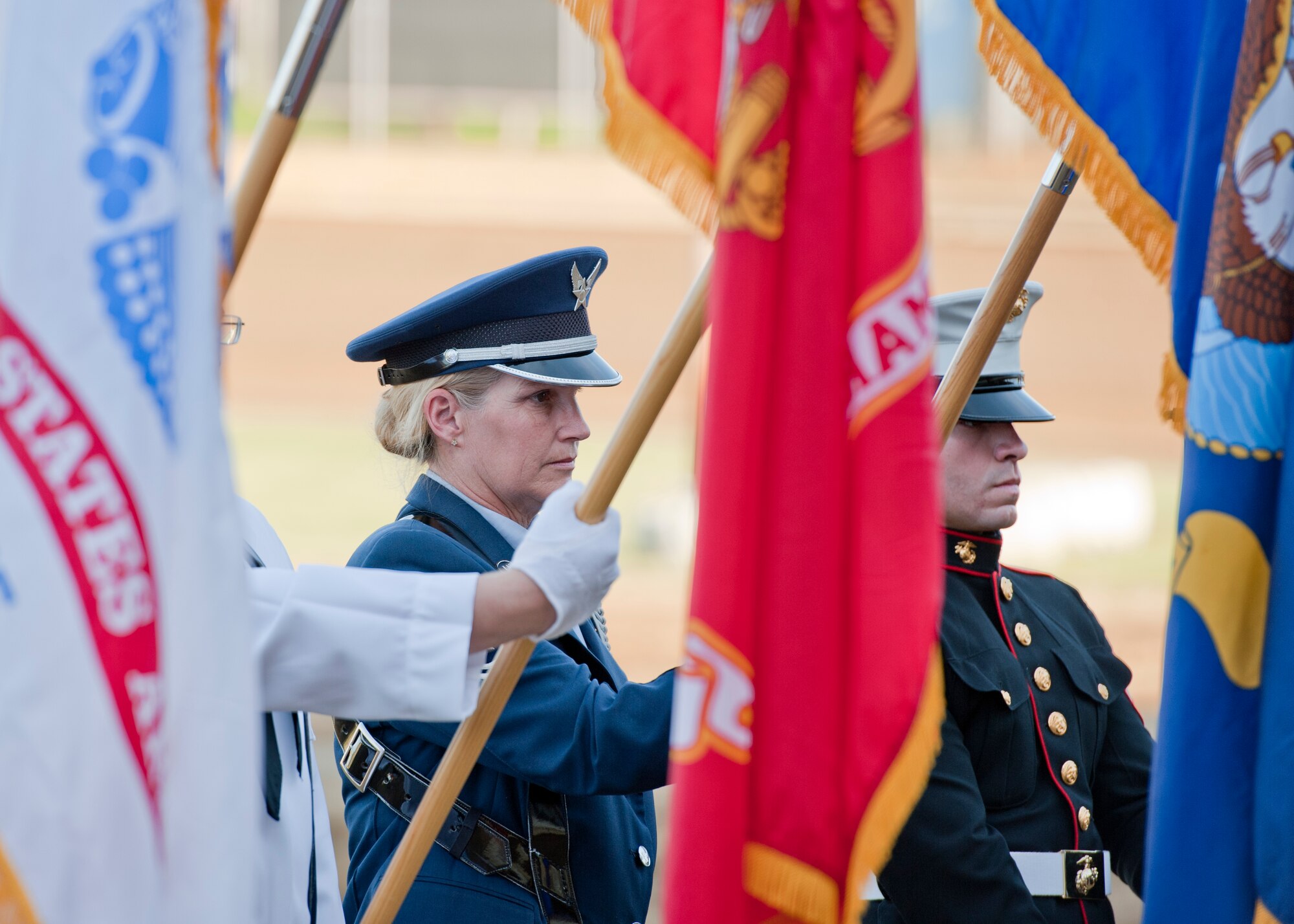 U.S. Air Force Reserve Master Sgt. Cindy Cox, an aircrew flight equipment craftsman with the 910th Operations Support Squadron, presents the Air Force flag during the opening ceremony of a race at Sharon Speedway Saturday, May 19, 2012. A Joint Service Color Guard including three Soldiers from the Hermitage National Guard Armory, a Marine reservist and Navy reservist from Youngstown Air Reserve Station, Ohio, and Sgt. Cox participated in the event that honored Armed Forces Day. The 910th Airlift Wing also provided a C-130H Hercules aircraft flyover for the event.