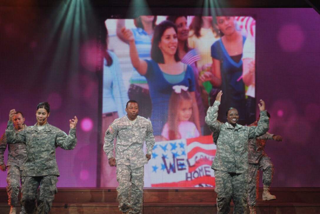 U.S. Army Soldiers rock the house during the 2012 U.S. Army Soldier Show at Joint Base Langley-Eustis, Va., May 15. The 90-minute, all-original show had no slow moments as lights flashed and images of soldiers with their families, protecting the country and participating in other events synced perfectly on a giant screen with their movements and words. (Courtesy photo by Toni Guagenti/Released) 