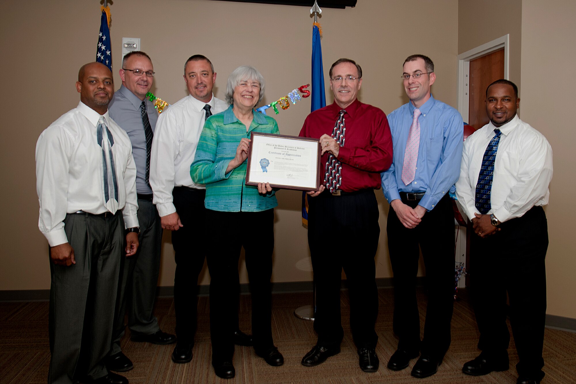 Mary Dixon, Defense Manpower Data Center director, presents the fiscal year 2011 Real Time Automated Personnel Identification System Site of the Year Award to members of the 23d Force Support Squadron’s Military Personnel Section customer service team May 23, 2012, at Moody Air Force Base, Ga. Of the more than 1,600 RAPIDS issuance sites in the DoD, five were nominated for the award, and Moody was selected as the winner. During the year, Moody provided the best Common Access Card issuance services with minimal failure rates and security management issues. (U.S. Air Force photo by Staff Sgt. Jamal D. Sutter/Released)  
