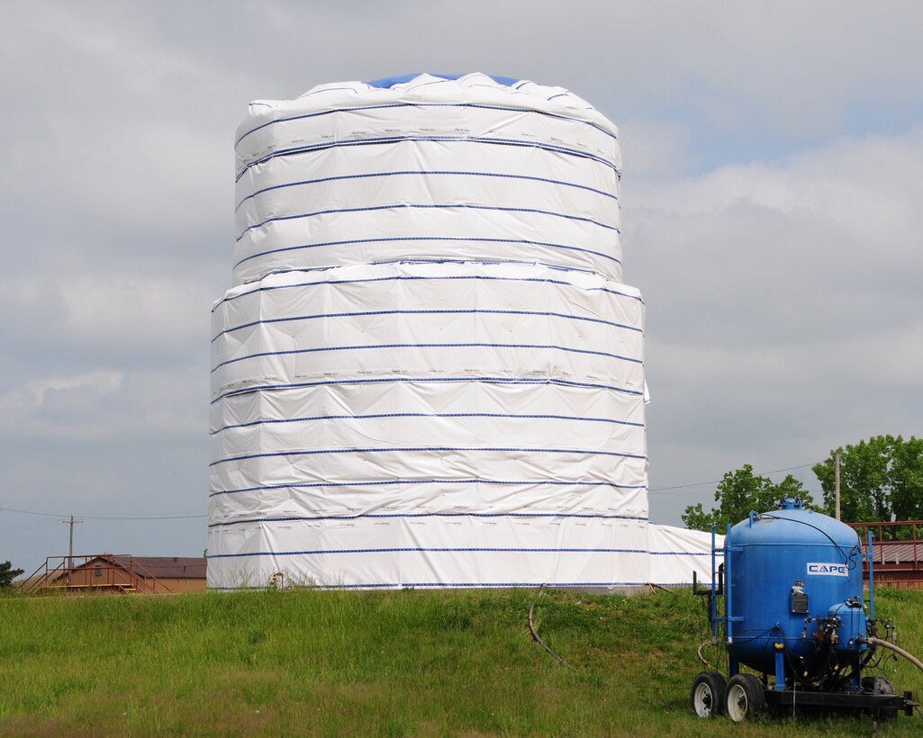 From afar this structure may look like a huge birthday cake without candles, but in reality it is a protective wrap that covers a fuel cell tank used to store fuel for the C-130 aircraft at the Niagara Falls Air Reserve Station, N.Y. on May 23, 2012. The tank now empty will be repainted from both the interior and exterior surfaces for corrosion control. The project  is expected to be completed in late July when a secondary fuel tank will go through the same process. (U.S. Air Force photo by Peter Borys)