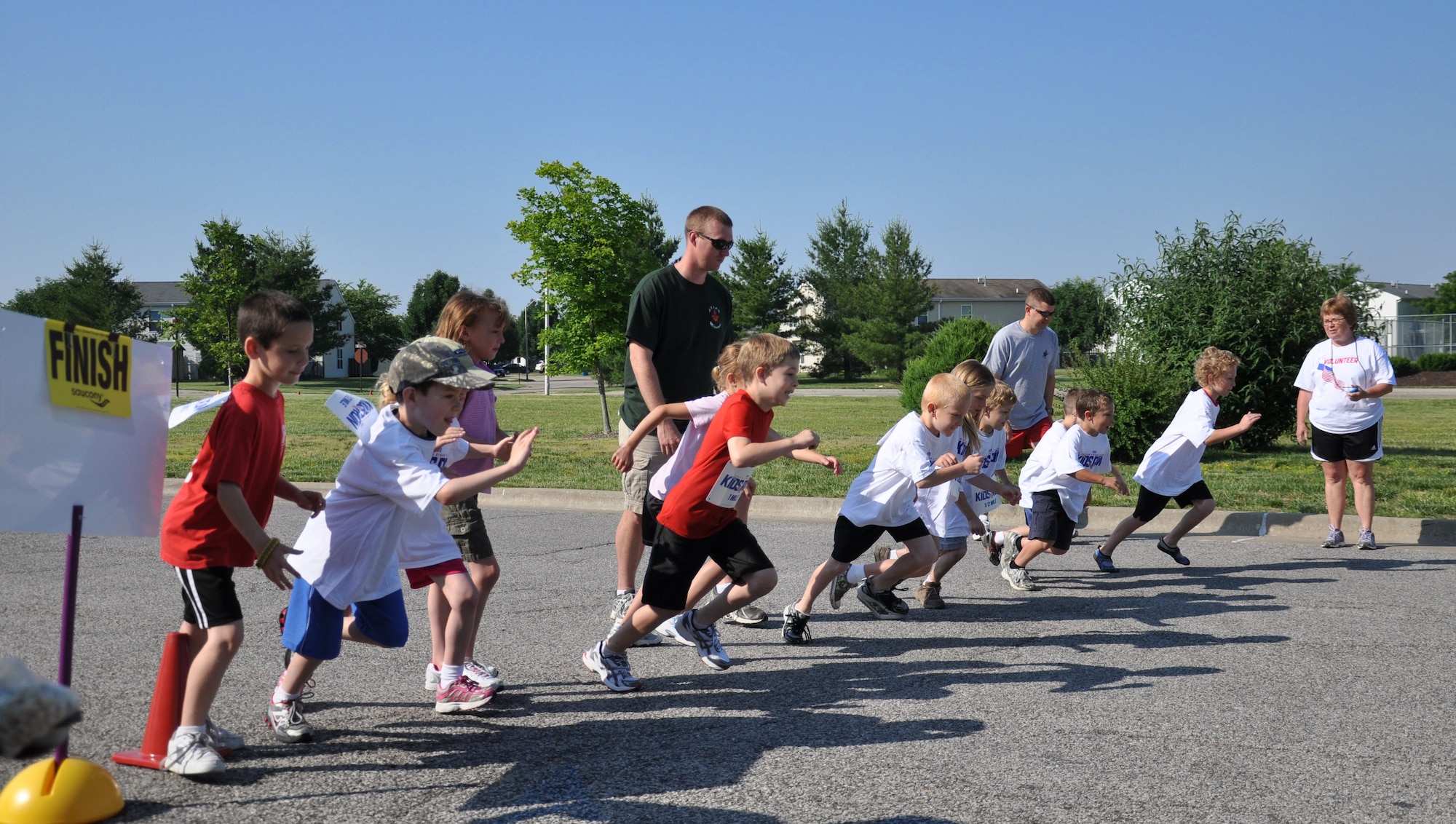 Children that participated in the America Kid’s Run start the mile run at Scott May 19.  The run started at the Youth Center, went around Patriots Landing then ended at the Youth center. Children from the ages of 5 to 8 ran half a mile, 9 and 10 year olds ran 1 mile, and 11 and up ran two laps around Patriots Landing.(U.S. Air Force photo/Airman 1st Class)