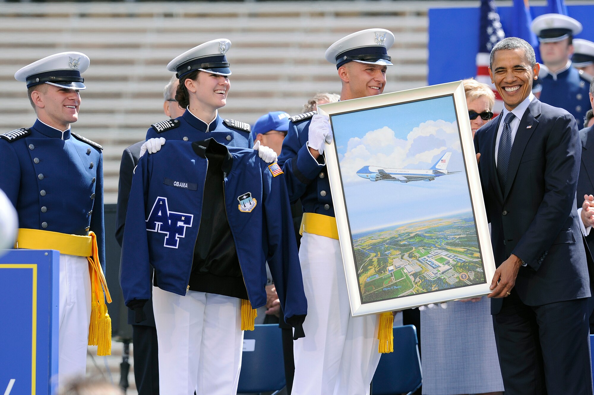 President Barack Obama receives a gift from senior ranking cadets after delivering the commencement address to the Air Force Academy's Class of 2012 at Falcon Stadium May 23, 2012. (U.S. Air Force photo/Mike Kaplan)