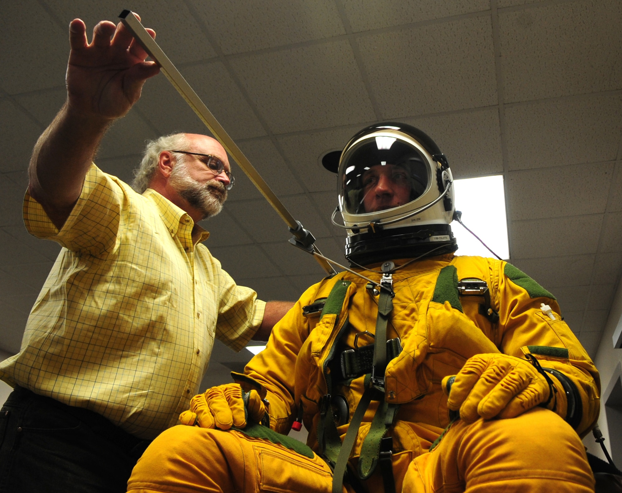 Dr. Gregory Zehner, 711th Human Performance Wing senior physical anthropologist, measures Airman 1st Class Alexander Scott, 9th Maintenance Squadron U-2 phase technician, while he wears a full pressure suit for a study at Beale Air Force Base, Calif., May 22. After baseline measurements, the suit was then inflated to simulate loss of cockpit cabin pressure at high altitudes. Experts, such as Zehner, from the Air Force Research Laboratory, Wright-Patterson Air Force Base, Ohio, visited here May 21-24 to investigate how big or small a pilot can be and still function in the cockpit of a U-2 Dragon Lady. (U.S. Air Force photo by Senior Airman Shawn Nickel)