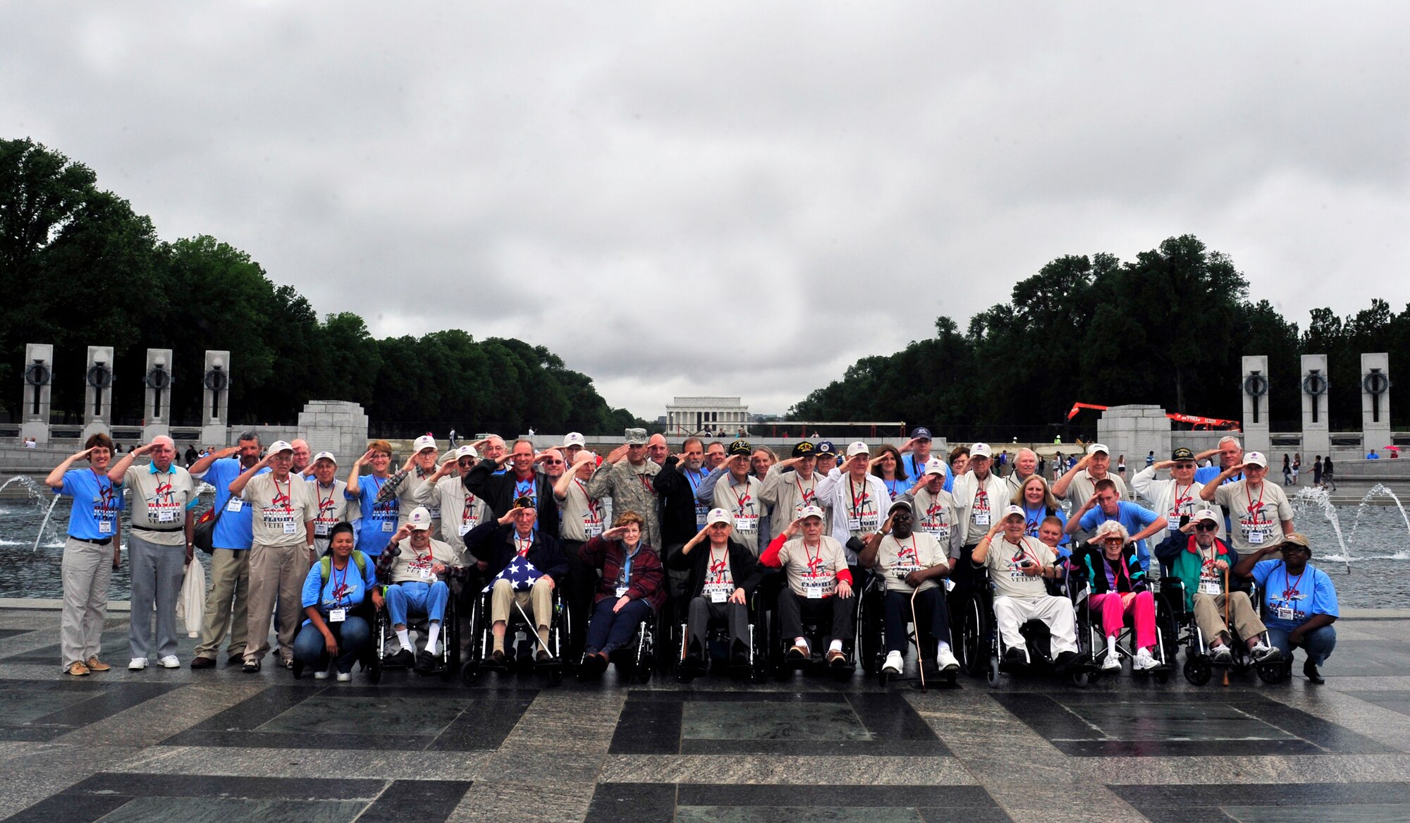 On a trip to the Washington D.C. memorials 26 World War II veterans and their guardians pose for a group photo outside the WWII memorial May 21 during an Honor flight trip. Honor flight is a program that transports World War II veterans once a month to in Washington, D.C. to view the National World War II, Korean war, Lincoln and Vietnam memorial, the a viewing of “The Changing of the Guard” at Arlington National Cemetery, Iwo Jima and ending with the U.S. Air Force memorial. For most of the veterans this was their first time viewing the memorials.  (U.S. Air Force photograph/ Staff Sgt. Stephenie Wade)