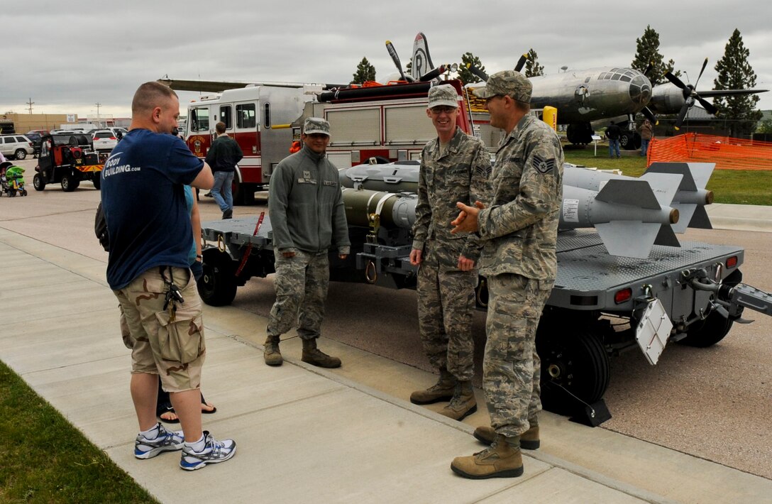 Airmen from the 28th Munitions Squadron explain what their jobs entail to visitors during the Heritage Day celebration at the South Dakota Air and Space Museum in Box Elder, S.D., May 19, 2012. Visitors were able to see numerous displays and demonstrations while also being able to ask questions about what Airmen do every day. (U.S. Air Force photo by Airman 1st Class Anania Tekurio/Released)