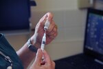 A 902nd Force Support Squadron veterinary technician draws vaccine to prepare for the next patient May 21 at the Joint Base San Antonio-Randolph veterinary clinic May 21.  (U.S. Air Force photo by Rich McFadden) 