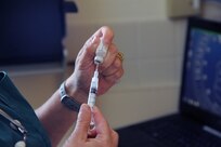A 902nd Force Support Squadron veterinary technician draws vaccine to prepare for the next patient May 21 at the Joint Base San Antonio-Randolph veterinary clinic May 21.  (U.S. Air Force photo by Rich McFadden) 