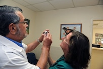 Dr. Richard Avery, 902nd Force Support Squadron veterinarian, and Margaret Williamson, 902nd FSS veterinary technician, examine a chihuahua puppy May 21 at the Joint Base San Antonio-Randolph veterinary clinic. (U.S. Air Force photo by Rich McFadden) 