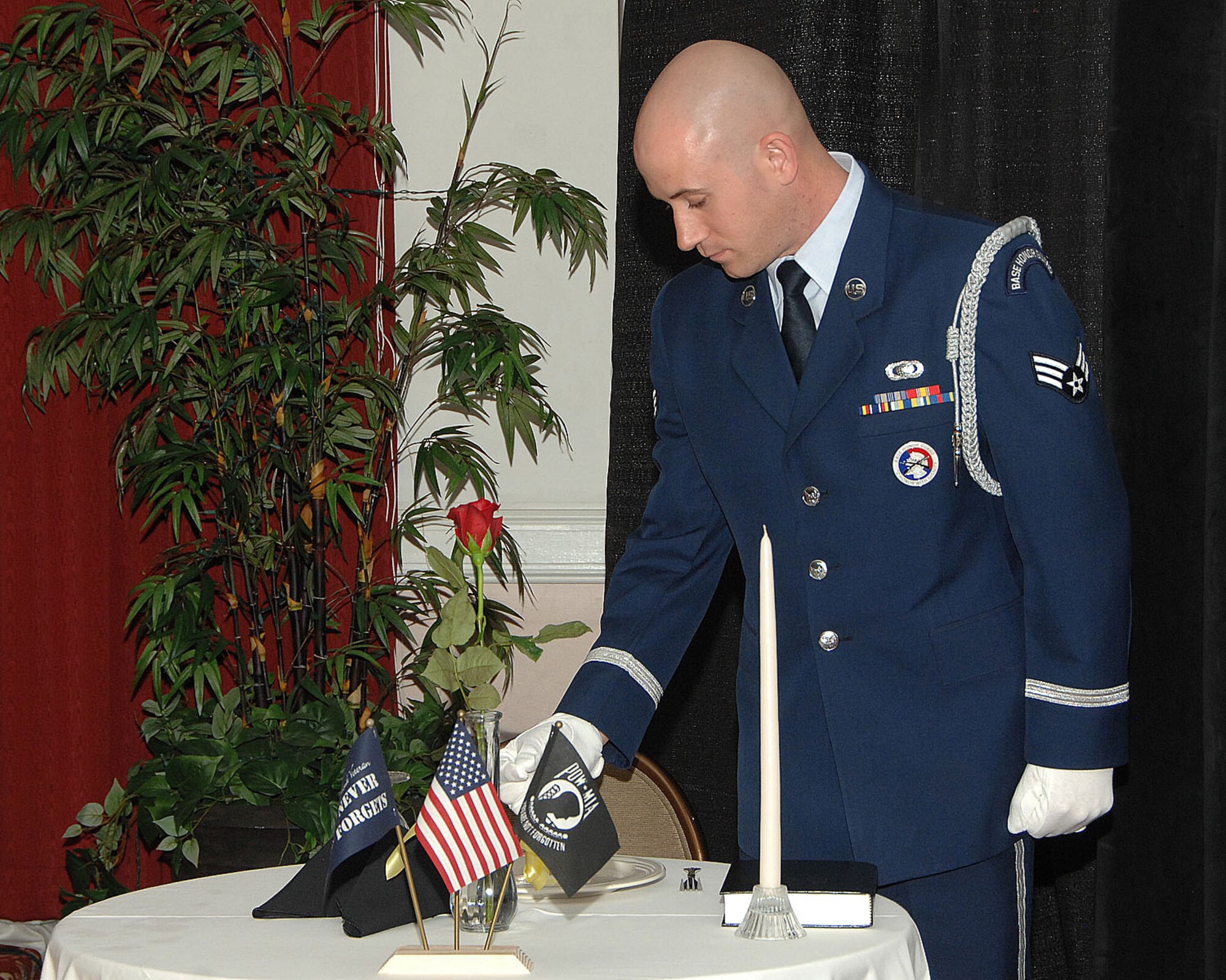 HANSCOM AIR FORCE BASE, Mass. - Senior Airman Kevin Phillips leads a ceremony for prisoners of war and servicemembers missing in action at the Honor Guard Banquet May 19 at the Minuteman Commons. The POW/MIA ceremony is held during the annual banquet to honor and remember fallen comrades. (U.S. Air Force photo by Linda LaBonte Britt)