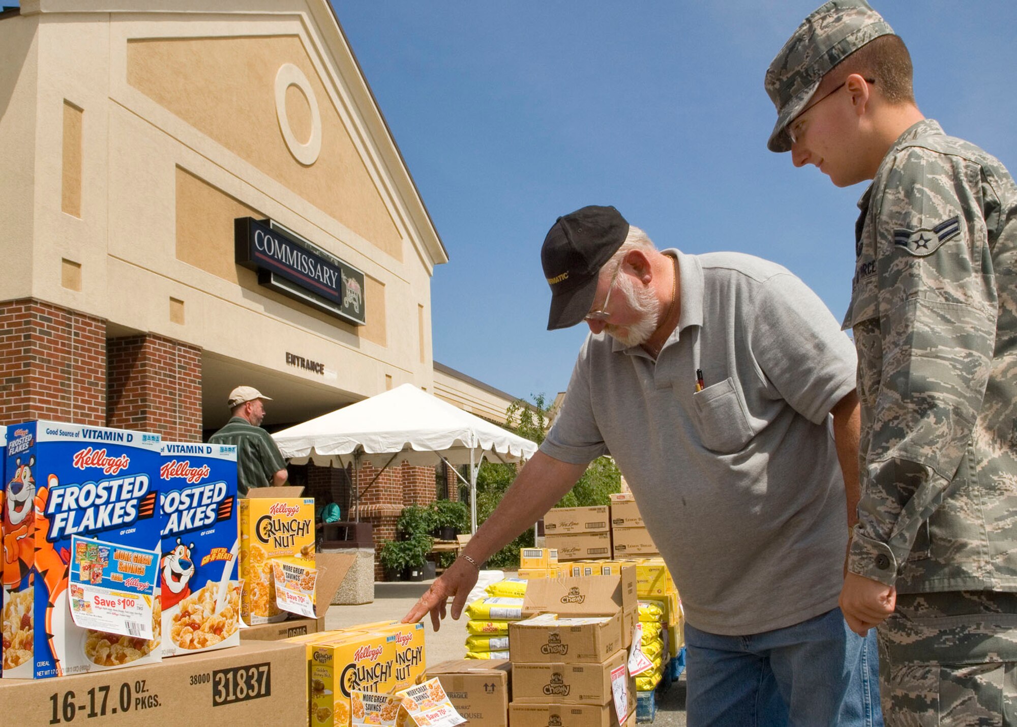 HANSCOM AIR FORCE BASE, Mass. -- Airman 1st Class Lawrence Root, a recent graduate of the Intelligence Analyst School at Goodfellow Air Force Base, Texas, shops at the Commissary’s case lot sale with his uncle, Frank Root, May 18. Root is home on leave from training and is preparing to move to his first duty station in Hawaii soon. (U.S. Air Force photo by Mark Wyatt)