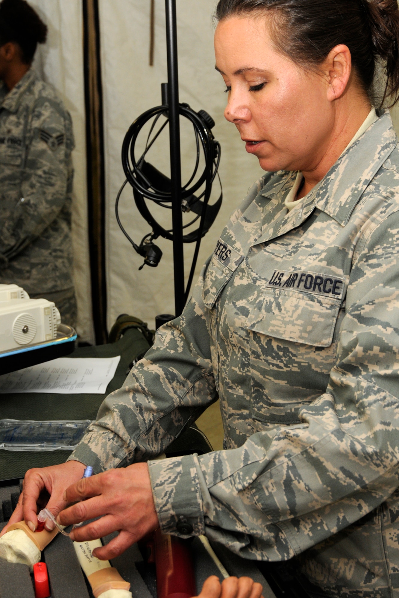 Technical Sgt. Trish Myers, 127th Medical Group, Michigan Air National Guard, practices a medical procdures during a training exercise at the Alpena Combat Readiness Training Center, Mich., May 23, 2012. The exercise brought together Airmen from eight medical groups from seven states. (U.S. Air Force photo by TSgt. David Kujawa)