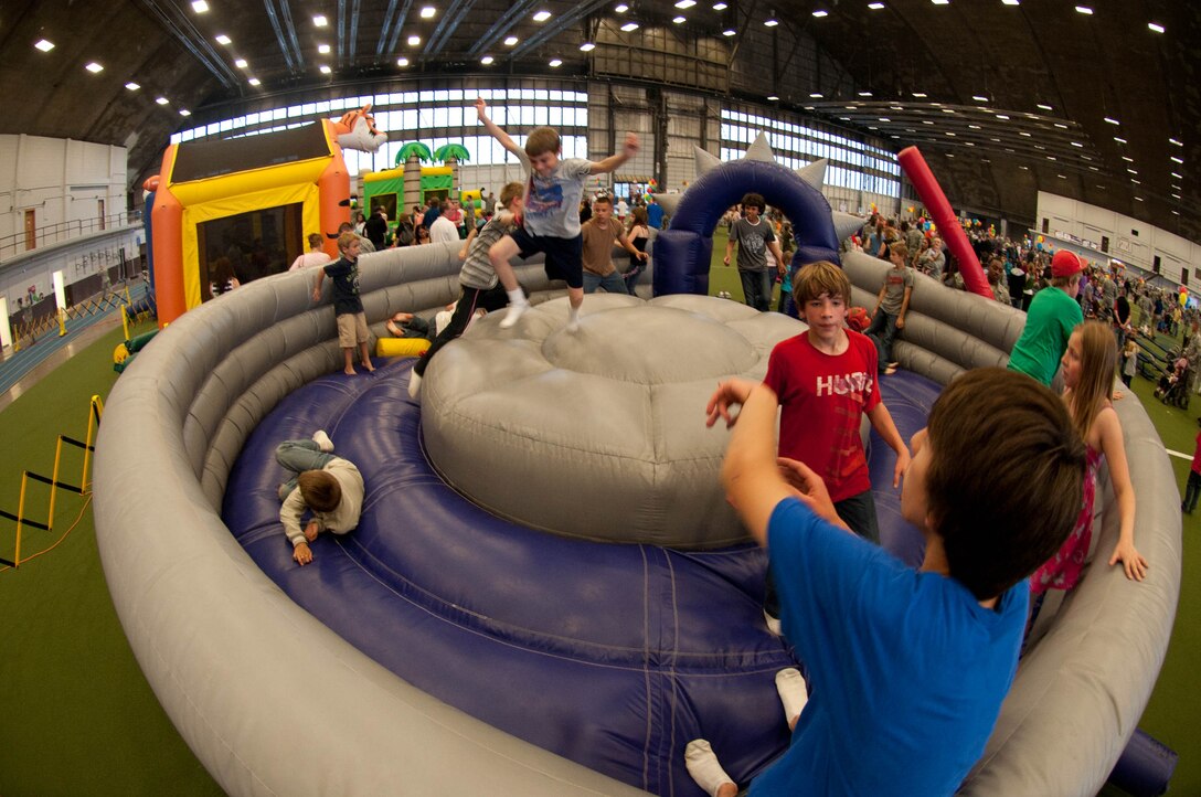 Children enjoy an inflatable castle at the Ellsworth’s 70th Anniversary Kick-Off Party at the Pride Hangar on Ellsworth Air Force Base S.D., May 18, 2012. In addition to free food and entertainment, guests were able to tour a static B-1 bomber, compete in table tennis and video game tournaments, and sing karaoke. (U.S. Air Force photo by Airman 1st Class Zachary Hada/Released)