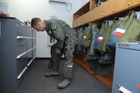 Lt. Col. Ripley Woodard, 415th Flight Test Flight commander, puts on his aircrew flight equipment prior to taking to the air in a T-38 Talon aircraft May 17on Joint Base San Antonio-Randolph, Texas. The T-38 is being returned to Sheppard Air Force Base, after modifications completed by the 571st Aircraft Maintenance Squadron here at JBSA-Randolph. (U.S. Air Force photo by Rich McFadden) 