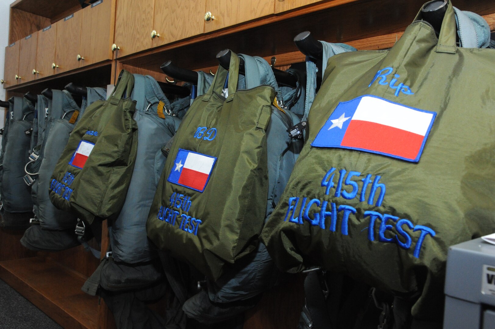 Helmet bags from the 415th Flight Test Flight  hang ready in the aircrew flight equipment room May 17 on Joint Base San Antonio-Randolph, Texas. (U.S. Air Force photo by Rich McFadden) 