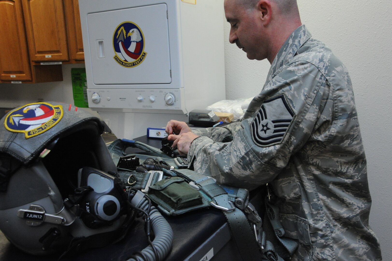 Master Sgt Jason Fisch, 415th Flight Test Flight aircrew flight equipment technician, inspects and repairs harnesses used by 415th FLTF pilots May 17 at Joint Base San Antonio-Randolph, Texas.  (U.S. Air Force photo by Rich McFadden) 