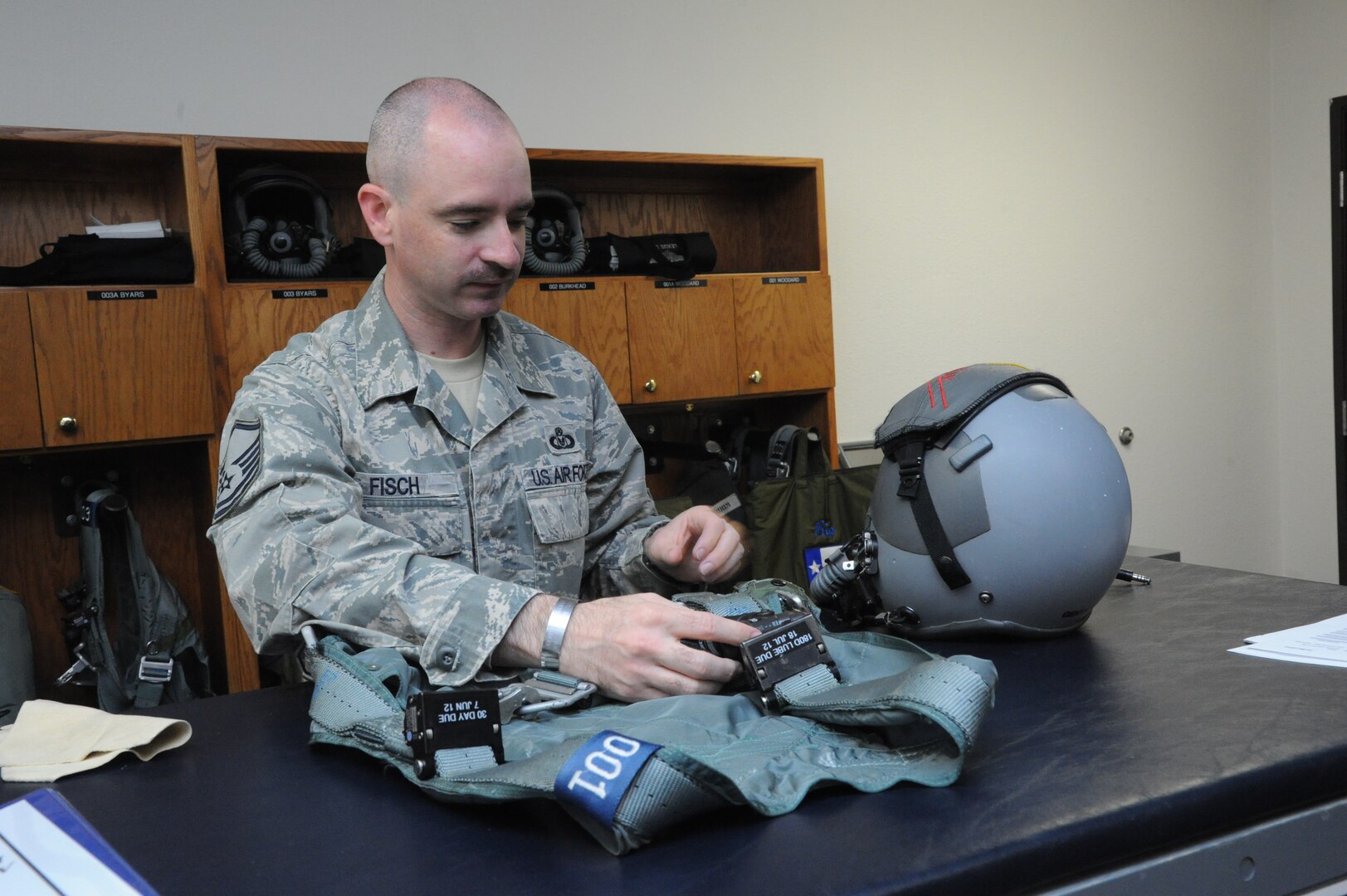 Master Sgt Jason Fisch, 415th Flight Test Flight aircrew flight equipment technician, inspects and repairs harnesses used by 415th FLTF pilots May 17 at Joint Base San Antonio-Randolph, Texas.  (U.S. Air Force photo by Rich McFadden) 
