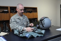 Master Sgt Jason Fisch, 415th Flight Test Flight aircrew flight equipment technician, inspects and repairs harnesses used by 415th FLTF pilots May 17 at Joint Base San Antonio-Randolph, Texas.  (U.S. Air Force photo by Rich McFadden) 