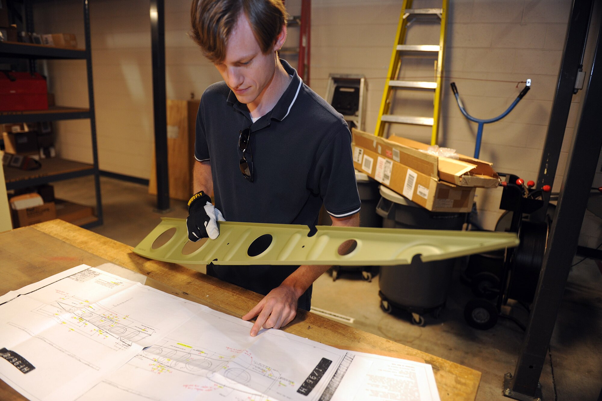 Matt Oliver, a C-130 structural engineer in the Aerospace Sustainment Directorate, performs visual inspection of incoming part prior to creating test plan. (U.S. Air Force photo by Tommie Horton)