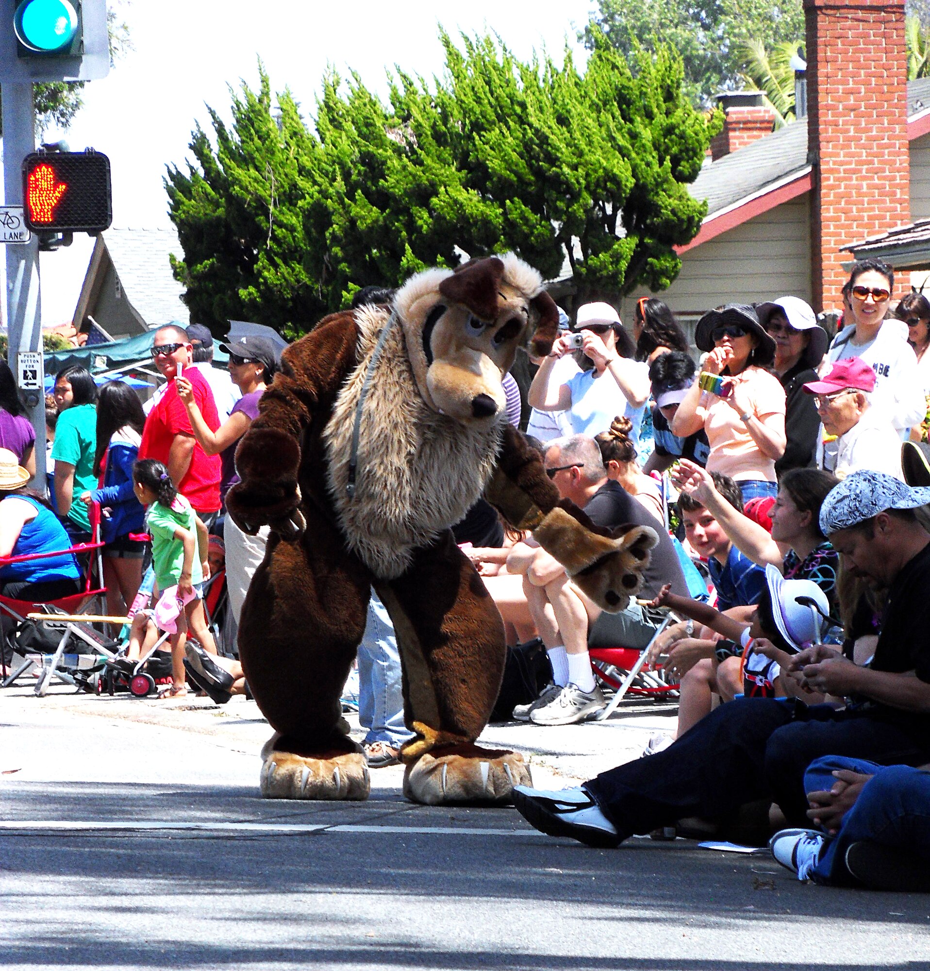 Eddie the Coyote, Edwards AFB mascot, visits with children at the parade. (Courtesy photo)