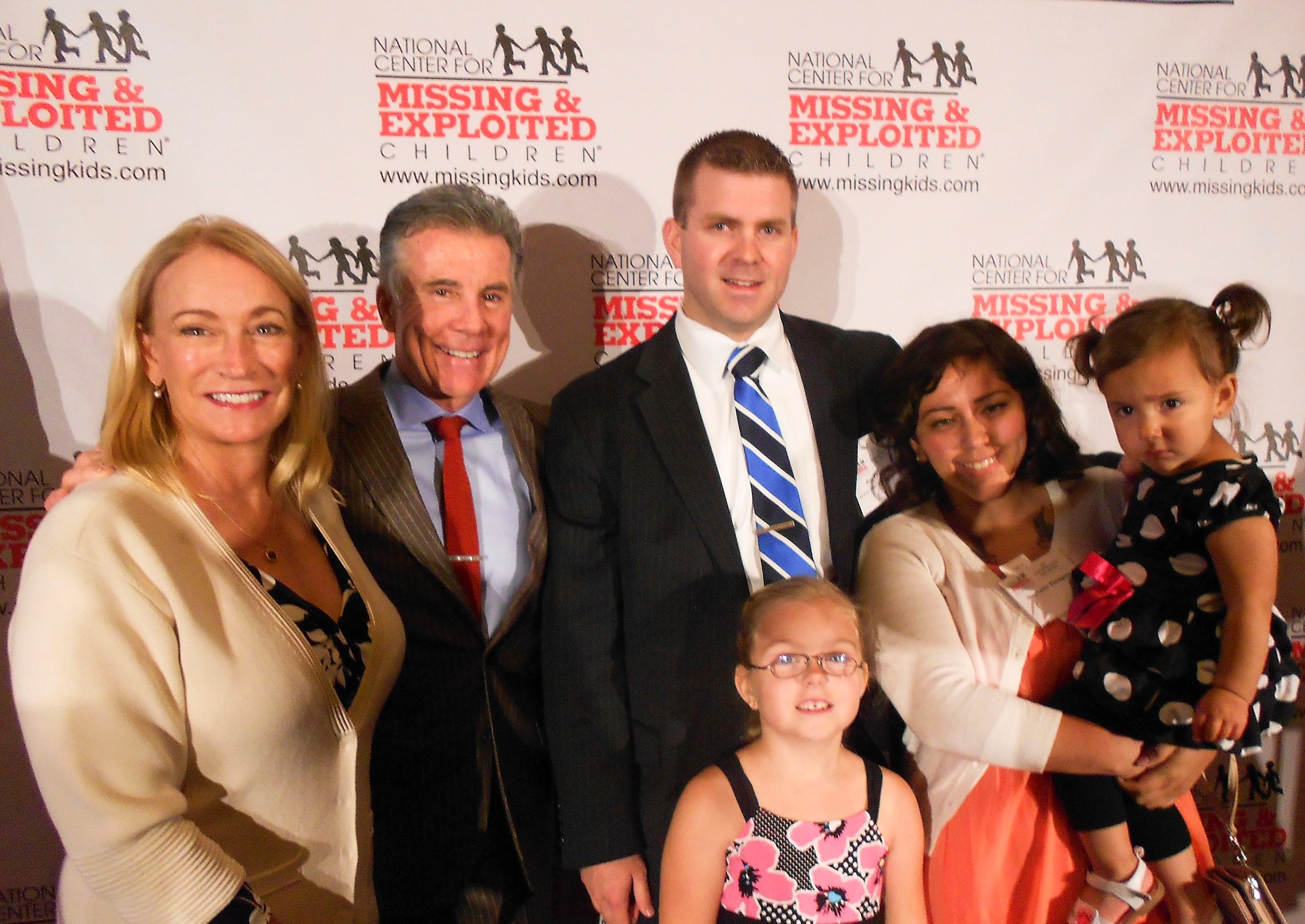 OSI Special Agent Jess Thompson and law enforcement officials from around the country, were honored May 23 for their efforts to recover missing children and resolve child sexual exploitation cases at the 17th Annual Congressional Breakfast and National law Enforcement Awards, in Alexandria, Va. Pictured, from left, are Mrs. Revé Walsh, Mr. John Walsh, host of Lifetime TV's "America's Most Wanted," and Thompson with his wife and children. (U.S. Air Force Photo by Maj. Don Day)

