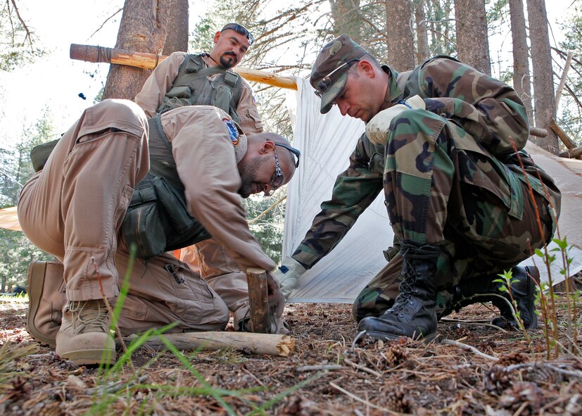 Ted Brooks (left), avionics technician on NASA’s Stratospheric Observatory for Infrared Astronomy next generation airborne observatory, and Michael Holtz, NASA Dryden Flight Research Center flight test engineer, attempt to build a shelter out of parachute material during an initial Survival Training course. The three-and-a-half-day course was held May 15-17, 2012, inside the Sequoia National Forest and is intended to train both military and civilian aircrew members the basic principles of survival in case they ever bailout or ditch in an unknown environment. (U.S. Air Force photo/Jet Fabara) 