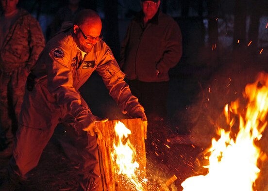 Ted Brooks attempts to transfer a fire he built after participating in a fire craft training exercise held at the Initial Survival Training course May 15, 2012. Brooks was one of seven aircrew members that participated in the three-and-a-half-day IST course that teaches non-combat level survival skills that aircrew will need in case they have to bailout or ditch in an unknown environment. Brooks is an avionics technician on NASA’s Stratospheric Observatory for Infrared Astronomy next generation airborne observatory. (U.S. Air Force photo/Jet Fabara) 