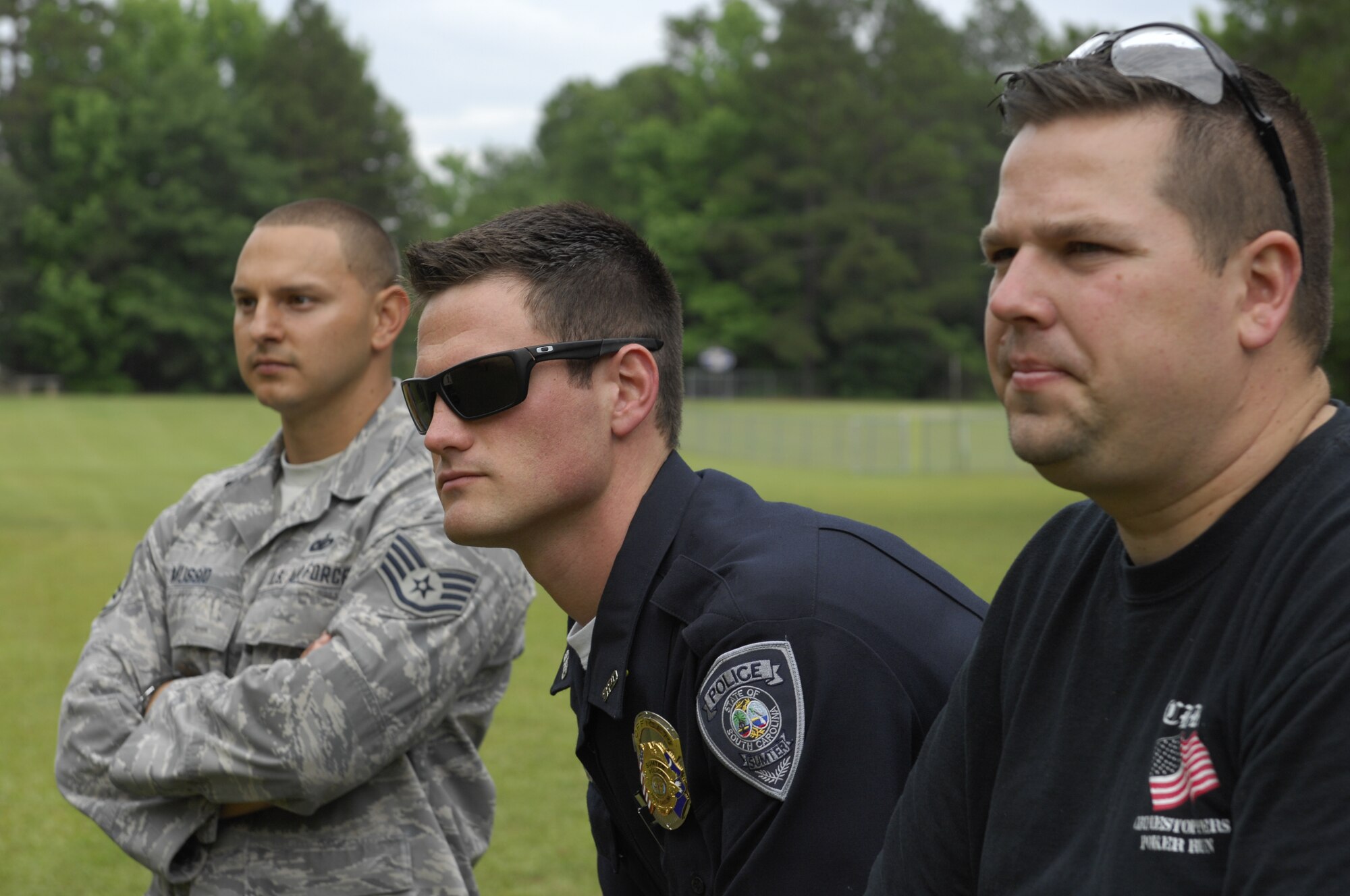 SHAW AIR FORCE BASE, S.C. – U.S. Air Force Staff Sgt. David A. Mussio, 20th Security Forces Squadron, Chase M. Ferguson, Sumter Police Department patrolman, and Police Cpl. Charles S. Bonner, Sumter Police Department dog handler, watched fellow policemen compete in a pistol tournament at the Sumter Police Department, S.C., firing range. The pistol tournament was one of the events of Police Week and branches of police officers gathered together to celebratealong with members of 20th SFS, state constables, members of Sumter County Sheriff’s Office, and local and state police. National Police Week was proclaimed in 1962 by President John F. Kennedy to honor policemen and their sacrifices to promote peace. (U.S. Air Force photo by Airman 1st Class Krystal M. Jeffers/Released)