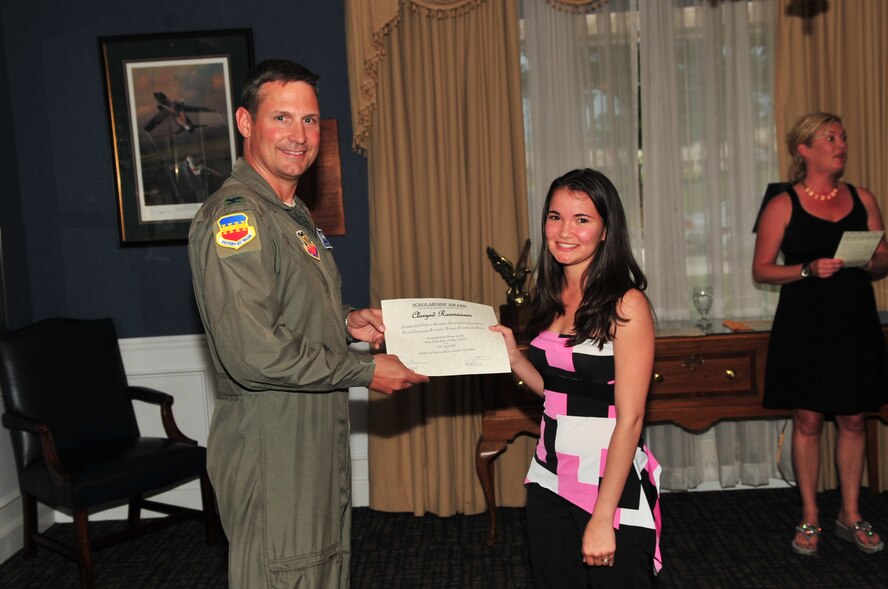 U.S. Air Force Col. Clay Hall, 20th Fighter Wing commander, poses for a photo with a scholarship award winner during the 2012 officer spouses' club and enlisted spouses' club dinner Shaw Air Force Base, S.C., May 15, 2012. (U.S. Air Force photo by Airman 1st Class Ashley L. Gardner/ Released)