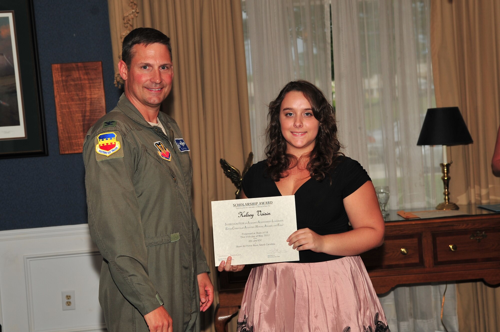 U.S. Air Force Col. Clay Hall, 20th Fighter Wing commander, poses for a photo with a scholarship award winner during the 2012 officer spouses' club and enlisted spouses' club dinner, Shaw Air Force Base, S.C., May 15, 2012. (U.S. Air Force photo by Airman 1st Class Ashley L. Gardner/ Released)