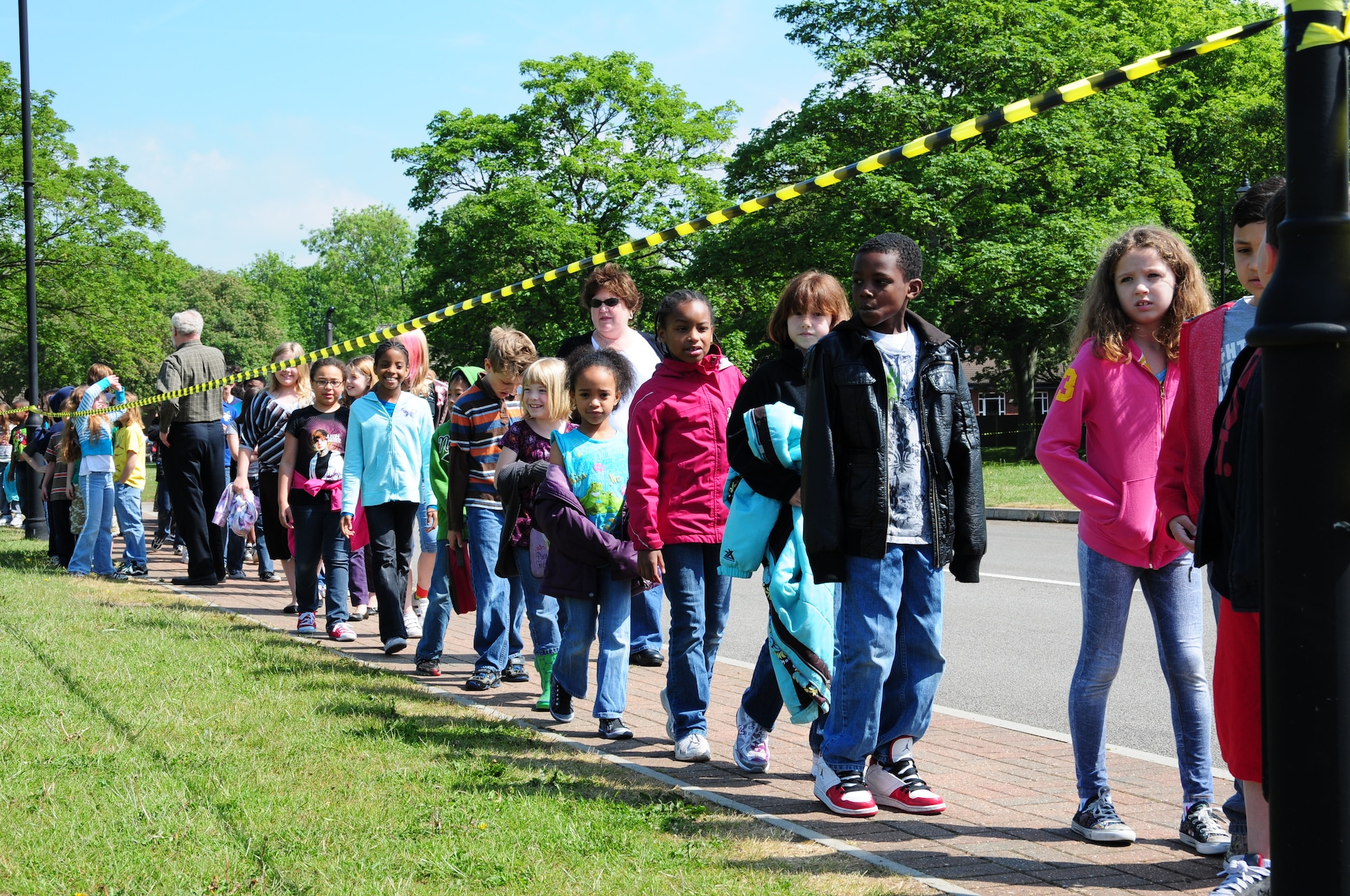 ROYAL AIR FORCE LAKENHEATH, England -- Students from RAF Feltwell Elementary School make their way to an open field to watch a helicopter demonstration June 2, 2010. Recently, U.S. Air Forces in Europe bases have experienced a series of unsuccessful child abduction attempts.  Wing leadership advises parents, students, teachers and 48th Fighter Wing personnel to be more vigilant and maintain situational awareness.  (U.S. Air Force photo by Airman 1st Class Lausanne Morgan)